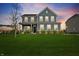 Charming two-story home with well-manicured lawn and inviting front porch at 12902 Girvan Way, Fishers, IN 46037