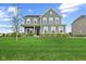 Charming two-story home with well-manicured lawn and inviting front porch at 12902 Girvan Way, Fishers, IN 46037