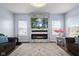 Comfortable living room featuring a modern fireplace, hardwood floors, and ample natural light at 12902 Girvan Way, Fishers, IN 46037