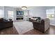 Stylish living room featuring a modern fireplace, hardwood floors, and ample natural light at 12902 Girvan Way, Fishers, IN 46037