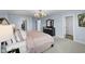 Inviting main bedroom with a dark dresser, plush bedding, and access to an organized walk-in closet at 12902 Girvan Way, Fishers, IN 46037
