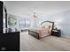 Spacious main bedroom with a large bed, a chandelier, and ample natural light from the windows at 12902 Girvan Way, Fishers, IN 46037