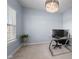 Home office with a glass desk, modern lighting, a window view, and neutral carpet at 12902 Girvan Way, Fishers, IN 46037