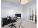 Home office with a glass desk, modern lighting, and a view to another room through a glass door at 12902 Girvan Way, Fishers, IN 46037