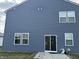 Rear exterior view of home showing sliding glass door leading to patio at 1303 Eton Way, Avon, IN 46123