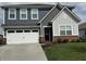 Charming two-story home with a well-manicured lawn, a two-car garage, and a welcoming front entrance at 1303 Eton Way, Avon, IN 46123
