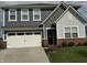 Charming two-story home with a well-manicured lawn, a two-car garage, and a welcoming front entrance at 1303 Eton Way, Avon, IN 46123