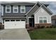 Charming two-story home with a well-manicured lawn, a two-car garage, and a welcoming front entrance at 1303 Eton Way, Avon, IN 46123