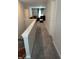 Hallway view with a glimpse of the living room, showcasing neutral walls and carpeted flooring at 1303 Eton Way, Avon, IN 46123