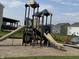 Community playground featuring a multi-level play structure with slides and climbing features at 1303 Eton Way, Avon, IN 46123