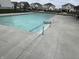 Large outdoor pool with a concrete deck and metal railings, perfect for relaxing on a hot day at 1303 Eton Way, Avon, IN 46123
