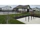 Community pool area featuring a modern pool house, black metal fence, and bike rack in a well-maintained green space at 1303 Eton Way, Avon, IN 46123