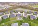 Beautiful aerial view features neighborhood homes surrounding a pond, showcasing multiple properties with pools at 1352 Trifecta Way, Westfield, IN 46074