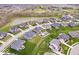 Aerial view shows a community with homes, ponds, and lush green spaces in a serene setting at 1352 Trifecta Way, Westfield, IN 46074