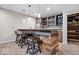 Basement bar with granite countertops, custom cabinetry, and seating at 1352 Trifecta Way, Westfield, IN 46074