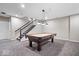 Basement rec room with an elegant pool table, carpet flooring and a staircase at 1352 Trifecta Way, Westfield, IN 46074