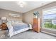 Comfortable bedroom boasts natural light, plush carpet, a ceiling fan and neutral paint at 1352 Trifecta Way, Westfield, IN 46074