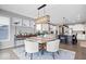 Bright dining area featuring large windows, modern lighting, and adjacent to the kitchen, perfect for gatherings at 1352 Trifecta Way, Westfield, IN 46074