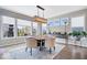 Sunlit dining area with large windows, contemporary light fixture, and comfortable seating with backyard views at 1352 Trifecta Way, Westfield, IN 46074