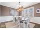 Elegant dining room with wainscoting, a modern light fixture, and large windows for natural light at 1352 Trifecta Way, Westfield, IN 46074