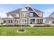 Beautiful two-story home featuring stone accents, a welcoming front porch, and professionally landscaped front yard at 1352 Trifecta Way, Westfield, IN 46074