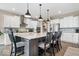Open kitchen features white cabinets, granite countertops, stainless appliances, and center island with seating at 1352 Trifecta Way, Westfield, IN 46074