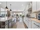 Bright kitchen featuring a farmhouse sink, granite countertops, and ample cabinet space with modern finishes at 1352 Trifecta Way, Westfield, IN 46074