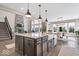 Spacious kitchen island overlooks the cozy living room, with modern lighting and countertops at 1352 Trifecta Way, Westfield, IN 46074