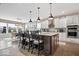Modern kitchen with granite countertops, stainless steel appliances, and a spacious center island with barstool seating at 1352 Trifecta Way, Westfield, IN 46074