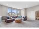 Spacious living room featuring a comfortable leather sectional, plush carpet and ample natural light at 1352 Trifecta Way, Westfield, IN 46074