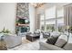 Elegant living room with stone fireplace, soaring ceilings, and large windows offering abundant natural light at 1352 Trifecta Way, Westfield, IN 46074