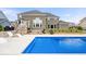 Inviting backyard pool with stamped concrete patio, outdoor stone fireplace, and meticulously maintained landscaping at 1352 Trifecta Way, Westfield, IN 46074