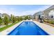 Relaxing backyard with a rectangular pool, stamped concrete patio, outdoor fireplace, and manicured landscaping at 1352 Trifecta Way, Westfield, IN 46074