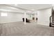 Finished basement with carpet flooring, a large space, and stairs to the main floor at 13567 Moorcroft Dr, Fishers, IN 46037