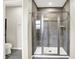 Modern bathroom with a tiled shower stall, glass doors, and sleek fixtures for a luxurious feel at 13567 Moorcroft Dr, Fishers, IN 46037
