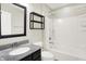 Bathroom with a single sink, a framed mirror, and a shower over tub with white tile surround at 13567 Moorcroft Dr, Fishers, IN 46037