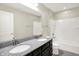 Bathroom with a double sink vanity featuring granite counters, and a shower-tub combo at 13567 Moorcroft Dr, Fishers, IN 46037