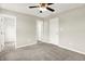 Comfortable bedroom featuring carpet, a ceiling fan, and easy access to the walk-in closet at 13567 Moorcroft Dr, Fishers, IN 46037