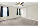 Carpeted bedroom with a ceiling fan, big closet, and window with curtains at 13567 Moorcroft Dr, Fishers, IN 46037