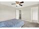 Neutral bedroom featuring a carpeted floor, ceiling fan and entry to the walk-in closet at 13567 Moorcroft Dr, Fishers, IN 46037