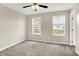 Cozy bedroom with carpet floors, a ceiling fan, and bright windows offering scenic views at 13567 Moorcroft Dr, Fishers, IN 46037