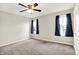 Carpeted bedroom featuring a ceiling fan, and window with curtains at 13567 Moorcroft Dr, Fishers, IN 46037