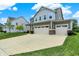 Inviting two-story home with three-car garage and spacious driveway in a suburban setting at 13567 Moorcroft Dr, Fishers, IN 46037