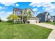 Beautiful two-story home with an attached garage and lush green lawn in a friendly neighborhood at 13567 Moorcroft Dr, Fishers, IN 46037