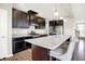Modern kitchen boasts dark cabinets, stainless steel appliances, granite counters and a large island at 13567 Moorcroft Dr, Fishers, IN 46037