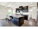 Stylish kitchen with a large island, pendant lighting, stainless steel appliances, and dark cabinetry at 13567 Moorcroft Dr, Fishers, IN 46037