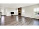 Spacious living room boasting hardwood floors, stone fireplace, and bright, airy atmosphere at 13567 Moorcroft Dr, Fishers, IN 46037