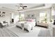 Luxurious main bedroom featuring a tray ceiling, ceiling fan, carpeted floors and a private bathroom at 13567 Moorcroft Dr, Fishers, IN 46037