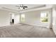 Large main bedroom with carpeted floors, tray ceiling, a ceiling fan and great natural light at 13567 Moorcroft Dr, Fishers, IN 46037