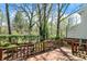 Enjoy a lovely wooden back deck with scenic views of lush greenery and mature trees at 13587 Kensington Pl, Carmel, IN 46032